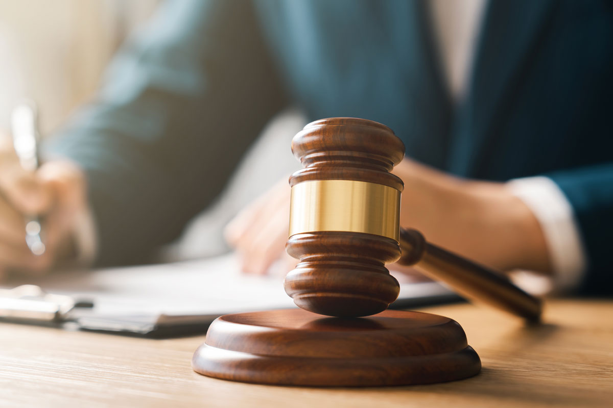 judge at desk with gavel in foreground
